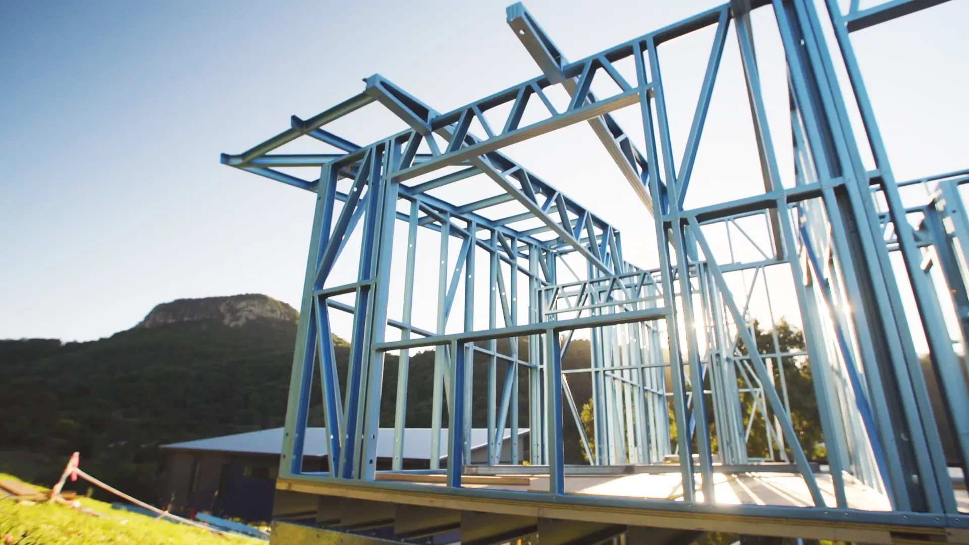 Steel-framed granny flat under construction on a sloping Sunshine Coast site