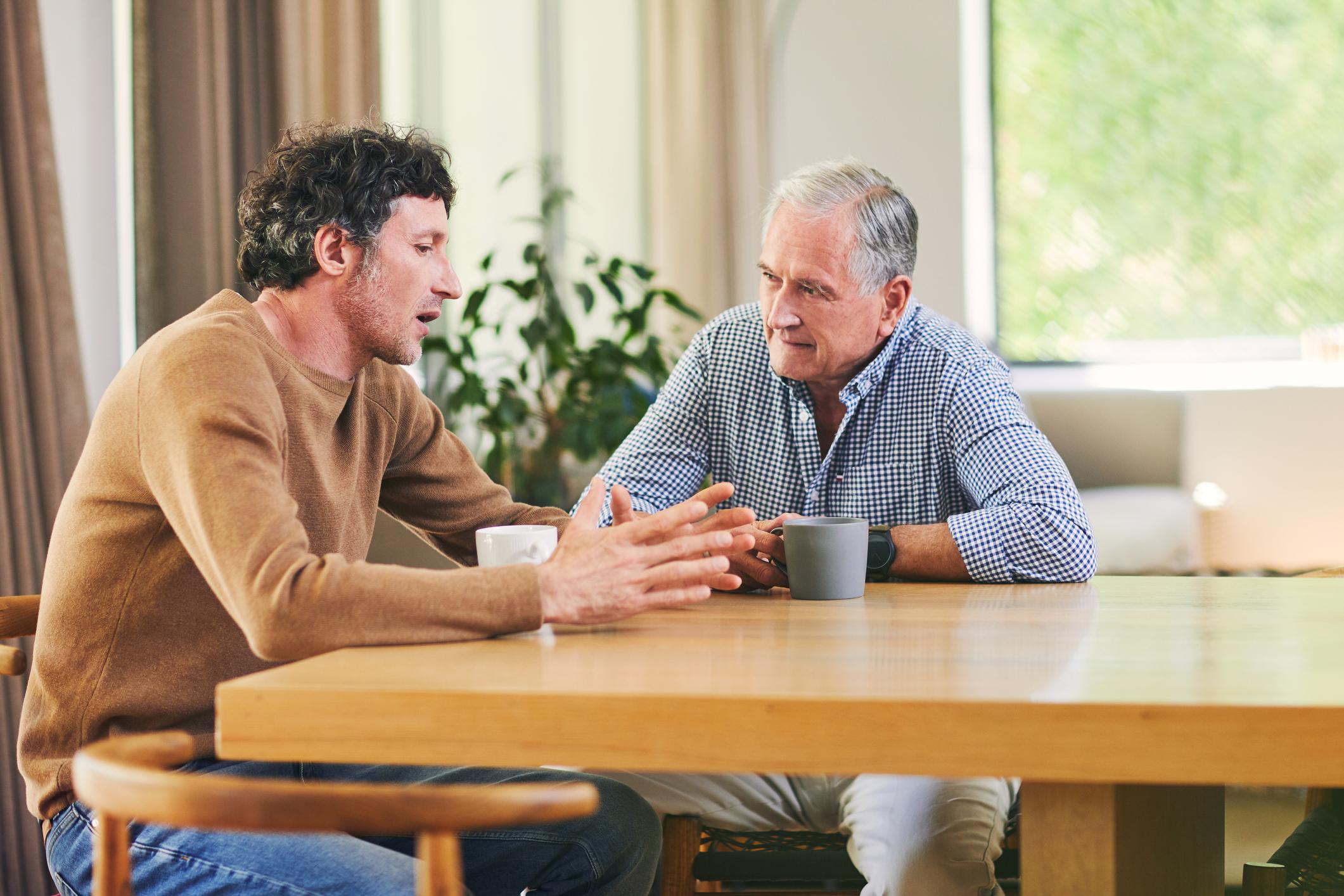 Adult child talking with an ageing parent about future living arrangements